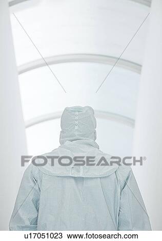Stock Image - Scientist in an isolation suit. Fotosearch