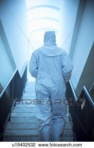 Stock Image - Scientist in an isolation suit. Fotosearch