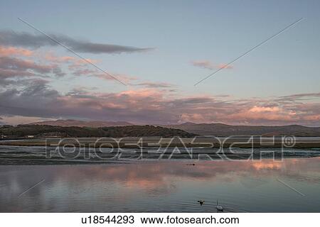 Sea and distant mountains at dawn, Porthmadog, Wales, UK View Large Photo Image Stock Image - Sea and distant mountains at dawn, Porthmadog, Wales, UK. Fotosearch
