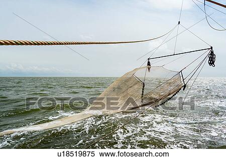 Stock Photography - Seine fishing nets of fishing boat on ocean, Waddenzee, Friesland, Netherlands. Fotosearch