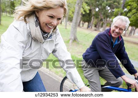 Senior couple cycling View Large Photo Image Stock Image - Senior couple cycling. Fotosearch