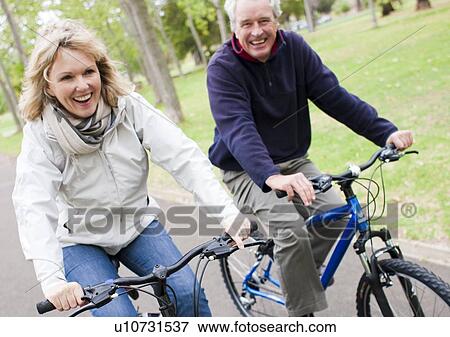 Senior couple cycling View Large Photo Image Stock Photo - Senior couple cycling. Fotosearch