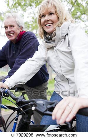 Stock Photo - Senior couple cycling. Fotosearch