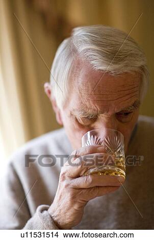 Senior man drinking whiskey View Large Photo Image Picture - Senior man drinking whiskey. Fotosearch