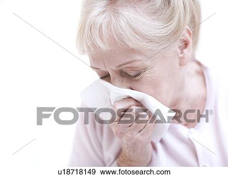 Stock Photo - Senior woman blowing her nose. Fotosearch