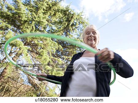 Senior woman hula-hooping View Large Photo Image Stock Image - Senior woman hula-hooping. Fotosearch