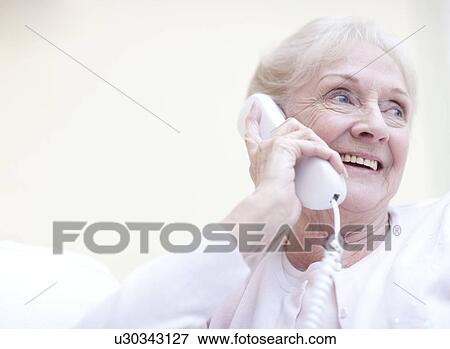 Senior woman talking on the telephone View Large Photo Image Stock Photo - Senior woman talking on the telephone. Fotosearch