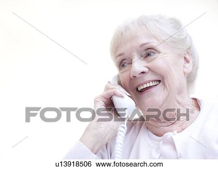 Stock Photograph - Senior woman talking on the telephone. Fotosearch