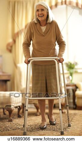 Stock Photograph - Senior woman with walking frame. Fotosearch