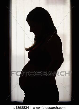 Stock Image - Silhouette of pregnant woman. Fotosearch