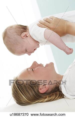 Stock Image - Sister and baby brother. Fotosearch