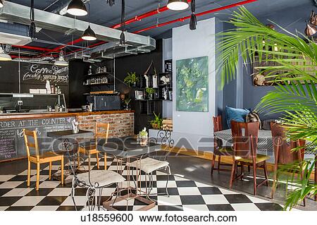 Stock Image - Tables and chairs in restaurant. Fotosearch