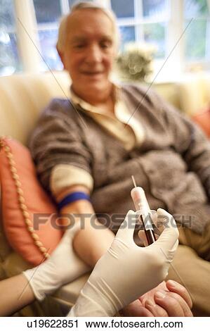 Stock Image - Taking a blood sample. Fotosearch