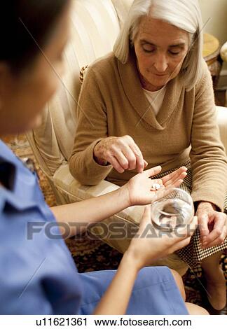 Stock Image - Taking medication. Fotosearch