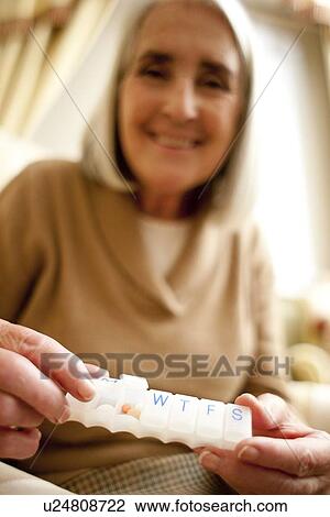 Stock Image - Taking medication. Fotosearch