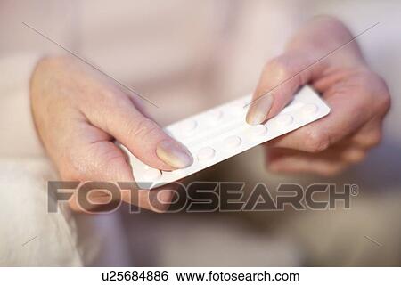 Stock Photograph - Taking medication. Fotosearch
