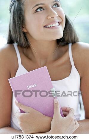 Picture - Teenage girl and her diary. Fotosearch