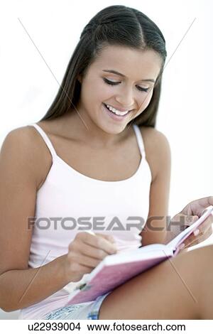 Picture - Teenage girl and her diary. Fotosearch