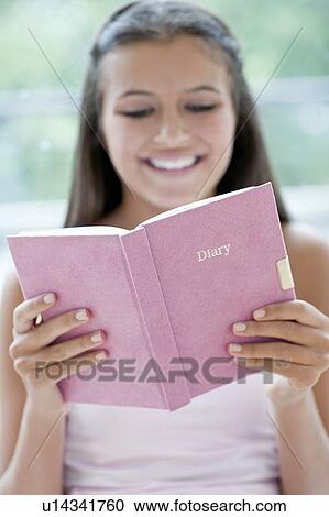 Stock Image - Teenage girl and her diary. Fotosearch