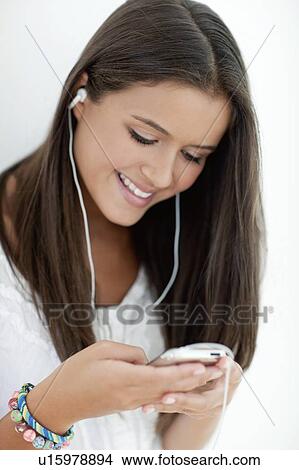 Picture - Teenage girl listening to music. Fotosearch