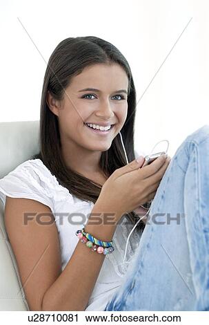 Stock Image - Teenage girl listening to music. Fotosearch