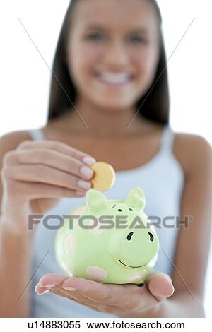 Stock Photography - Teenage girl saving money. Fotosearch