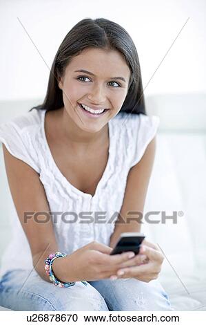 Stock Image - Teenage girl texting. Fotosearch