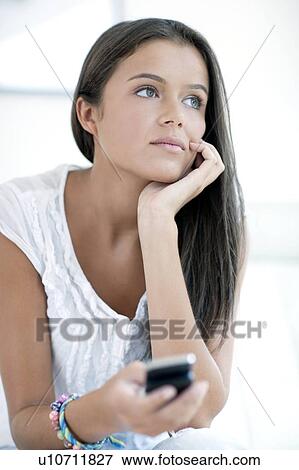 Stock Photo - Teenage girl texting. Fotosearch