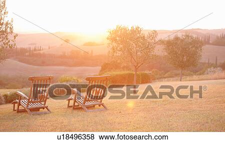Two garden deck chairs and sunrise landscape, Tuscany, Italy View Large Photo Image Stock Photo - Two garden deck chairs and sunrise landscape, Tuscany, Italy. Fotosearch