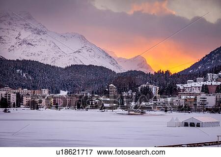 Village beneath mountain on snow covered landscape at sunset, Sankt Moritz, Switzerland View Large Photo Image Stock Photo - Village beneath mountain on snow covered landscape at sunset, Sankt Moritz, Switzerland. Fotosearch