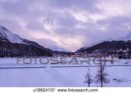 Village beneath mountain on snow covered landscape, Sankt Moritz, Switzerland View Large Photo Image Stock Photo - Village beneath mountain on snow covered landscape, Sankt Moritz, Switzerland. Fotosearch