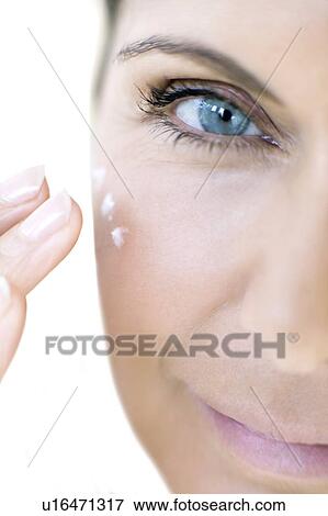 Woman applying face cream View Large Photo Image Stock Photo - Woman applying face cream. Fotosearch