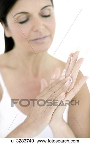 Woman applying hand cream View Large Photo Image Stock Photo - Woman applying hand cream. Fotosearch