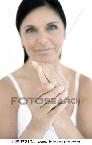 Stock Photo - Woman applying hand cream. Fotosearch