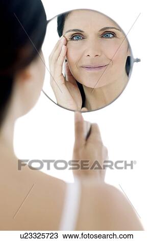 Woman checking for wrinkles View Large Photo Image Stock Image - Woman checking for wrinkles. Fotosearch