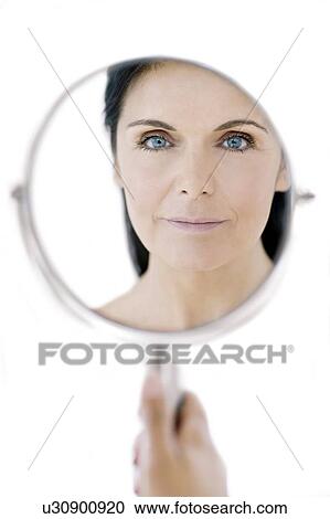 Stock Image - Woman checking for wrinkles. Fotosearch