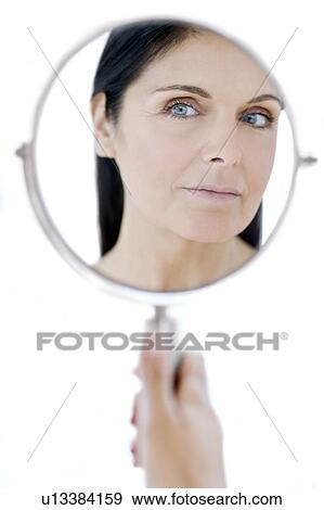 Stock Photo - Woman checking for wrinkles. Fotosearch
