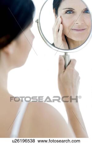 Woman checking for wrinkles View Large Photo Image Stock Photo - Woman checking for wrinkles. Fotosearch