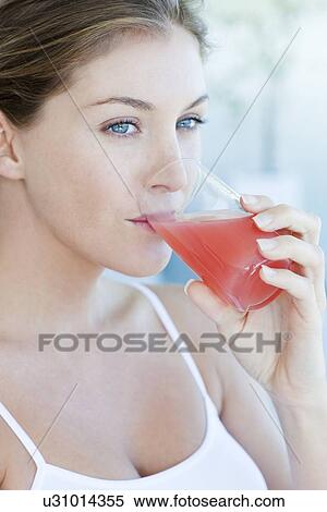 Stock Photography - Woman drinking cranberry juice. Fotosearch