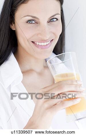 Woman drinking orange juice View Large Photo Image Stock Photo - Woman drinking orange juice. Fotosearch