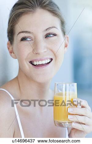 Stock Photo - Woman drinking orange juice. Fotosearch