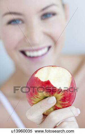 Woman eating an apple View Large Photo Image Stock Photography - Woman eating an apple. Fotosearch