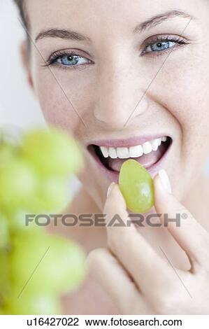 Woman eating grapes View Large Photo Image Stock Image - Woman eating grapes. Fotosearch