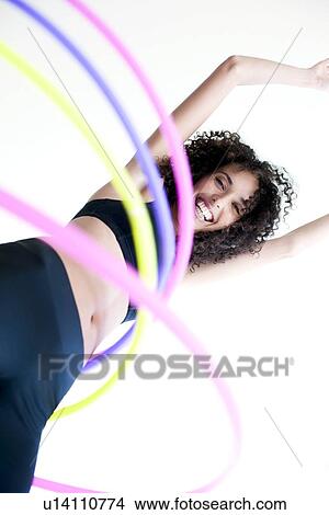 Picture - Woman hula-hooping. Fotosearch
