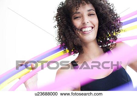 Stock Image - Woman hula-hooping. Fotosearch
