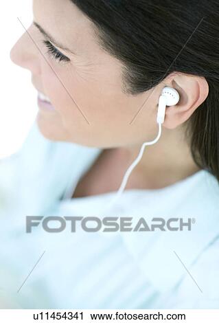 Woman listening to music View Large Photo Image Stock Image - Woman listening to music. Fotosearch