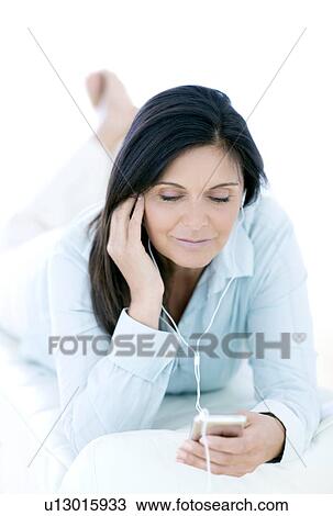 Woman listening to music View Large Photo Image Stock Image - Woman listening to music. Fotosearch