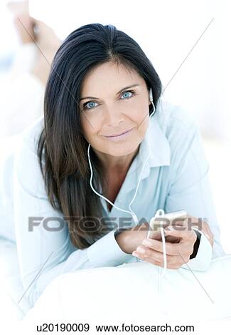 Woman listening to music View Large Photo Image Stock Photo - Woman listening to music. Fotosearch