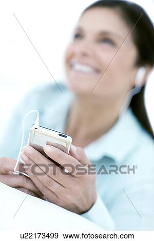Stock Photo - Woman listening to music. Fotosearch