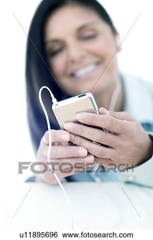 Stock Photograph - Woman listening to music. Fotosearch